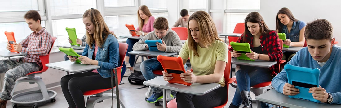 Students in a classroom each using a tablet computer