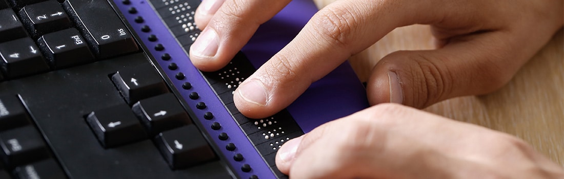 Hands on a braille keyboard