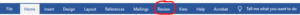 Microsoft Word ribbon menu with "Review" tab highlighted